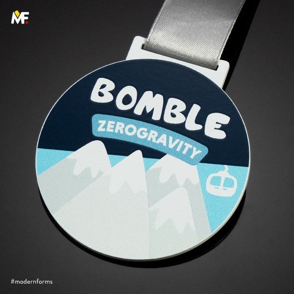 round white medal with mountains zerogravity bomble