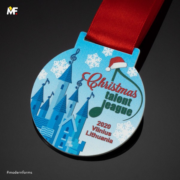 round blue medal with castle and green note christmas talent league